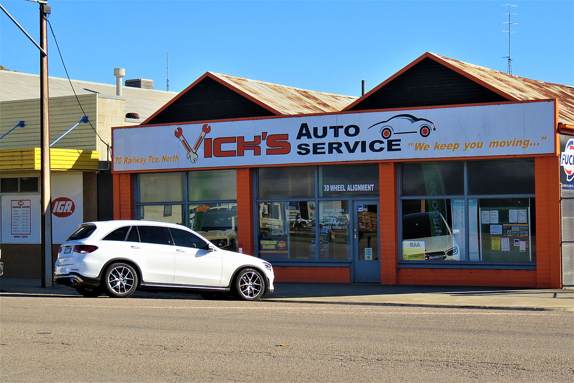 The Vick's Auto Service shopfront from the street, with the IGA next door